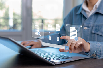 Digital document verification and file approval workflow concept. Business professional reviewing and validating online documents through modern document management system on laptop.