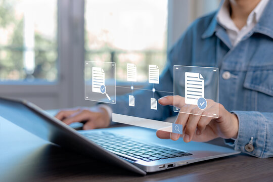 Digital document verification and file approval workflow concept. Business professional reviewing and validating online documents through modern document management system on laptop.