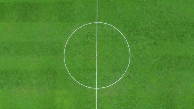 A modern football field with smooth turf and white boundary lines, ideal for players of all levels