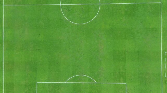 A wide green football field with crisp white markings, ready for exciting matches and team training.