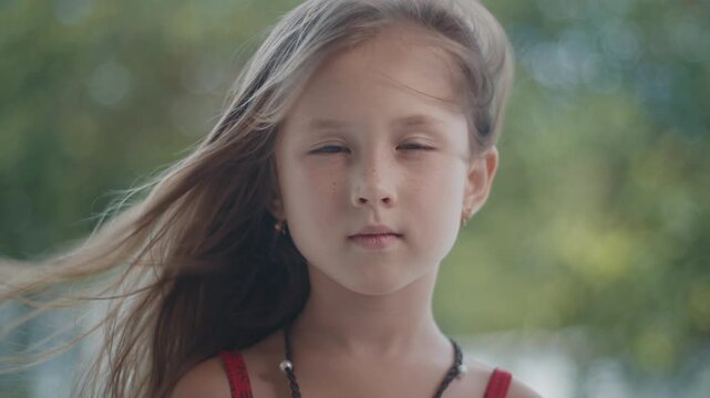 Portrait of the caucasian pre teen girl in the tropical garden
