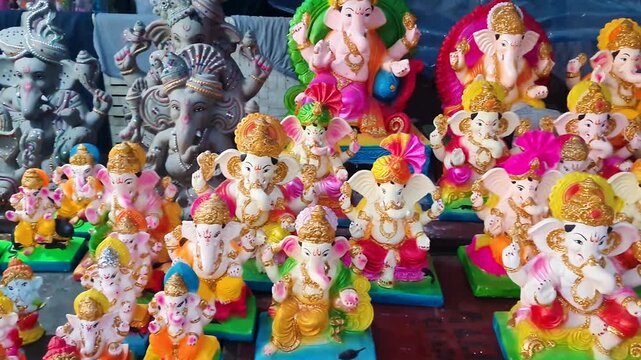 decorated ganesh murti with vibrant ornaments at local market stall