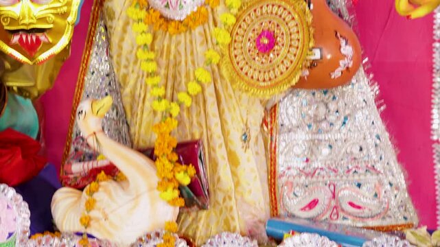 saraswati idol displayed during traditional festival honoring craftsmanship