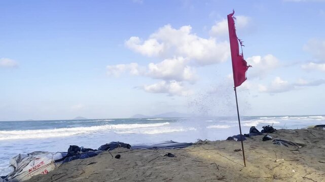 A cinematic shot of a red warning flag blowing in the wind
