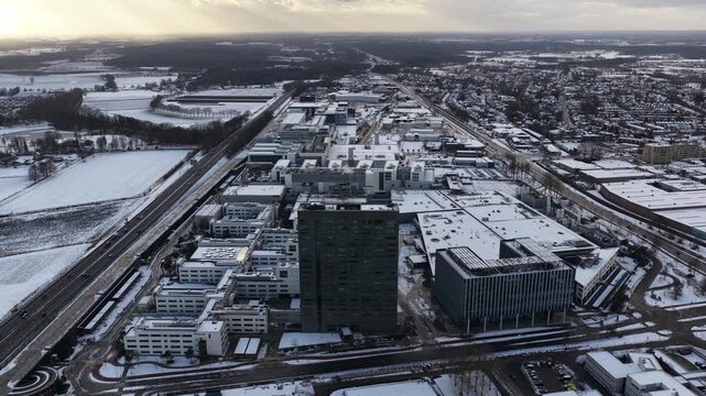 Aerial footage, ASML company grounds, building facades with ASML logos, cleanrooms, production halls, advanced semiconductor manufacturing facilities of the world&rsquo;s leading EUV lithography supplier.