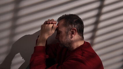 Man with headache, depression, sadness and loneliness at home