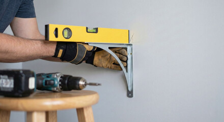 Man installing shelf bracket on wall for home maintenance