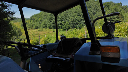 Old tractor for farm jobs in the countryside mountains.