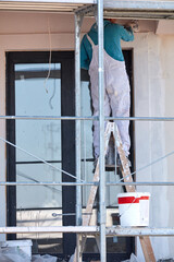 Repairman working on a new building facade.
