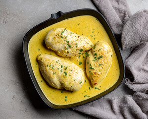 delicious chicken breast meat with creamy sauce on cooking pan