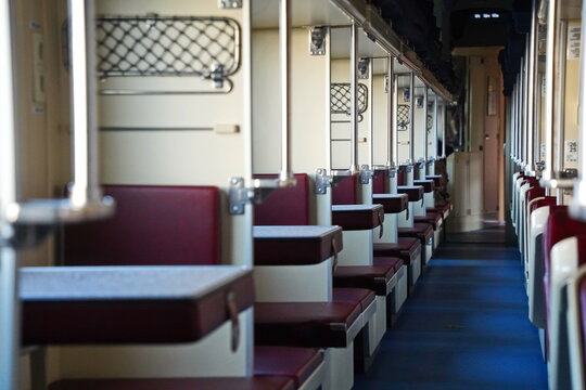 Sitting in a passenger train compartment.
