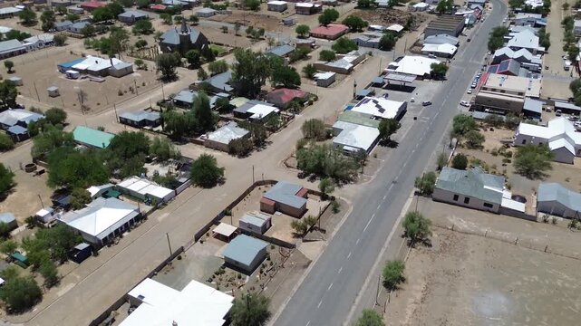Camera panning up along the main road of the small tourist town of Williston in the Karoo. 4K Aerial Video.