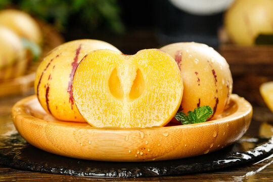 Fresh Yellow Ginseng Fruit Halves on Wooden Plate, Gansu Desert