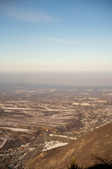 Heavy smog and air pollution covering Almaty city, Kazakhstan. Urban ecological crisis viewed from the Trans-Ili Alatau mountains