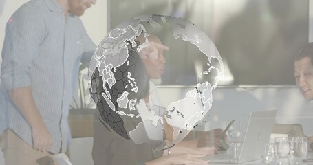 Discussing four colleagues in business attire working at meeting table, with laptops, globe overlay
