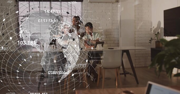 Discussing team of four wearing business attire around table at modern office, with digital globe - Powered by Adobe