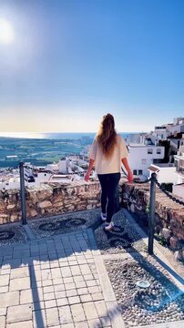 woman visiting city in Andalusia with famous white houses, Granada province, Salobre&ntilde;a. Traveling in Spain