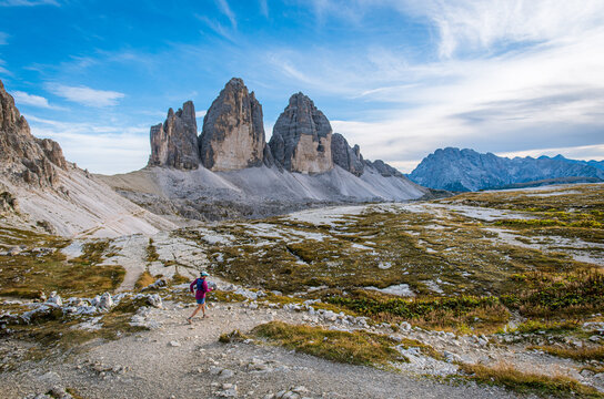 Woman trail running through the dramatic Tre Cime di Lavaredo