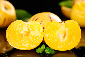 Fresh Yellow Melons Cut in Half with Mint Leaf © MinhChau