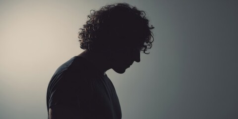 The Man Silhouette Against a Moody Gradient Studio Background with Dramatic Rim Lighting