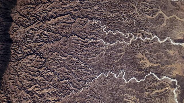 Satellite view of desert wadi patterns rotating background animation based on NASA imagery