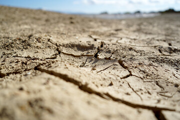 Cracked and dried mud in an empty dam, climate change image