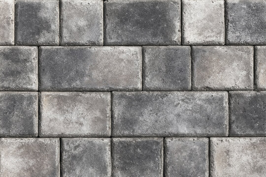 Textured gray interlocking paving stones forming a seamless background