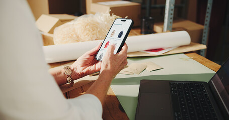 Ecommerce, startup and hands with phone screen, review and clothes for sale on website and...