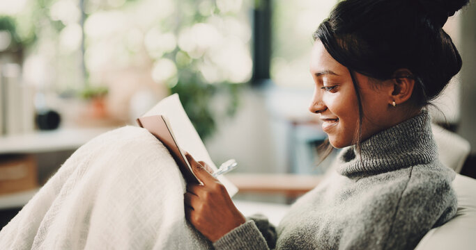 Happy, notebook and writing with woman on sofa for inspiration, journal prompt and reminder. Reflection, agenda and planning with person in living room of home for diary, checklist and brainstorming