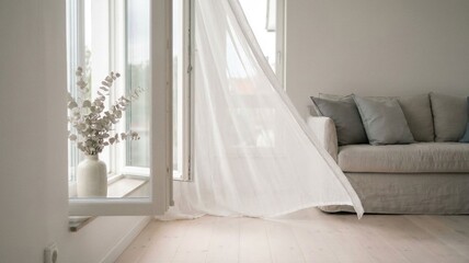 White curtains blowing in the breeze by open window