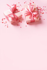 Valentines day concept with pink bow gift box and pink heart shape conffeti