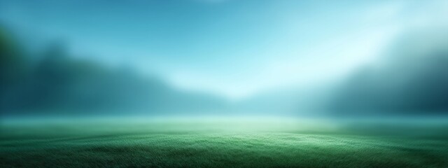 A field of grass with a blue sky in the background