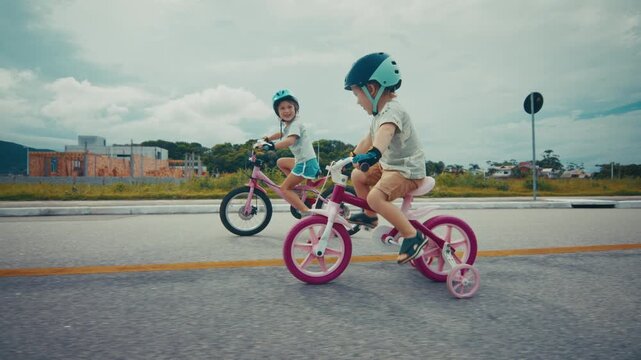 Boy and girl learn cycling on the safety city area with no traffic