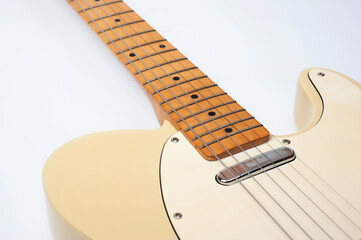 Six-string electric guitar, with a cream-colored wooden body and chrome-plated fittings.