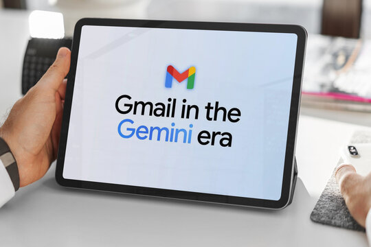 Person holding tablet displaying gmail and gemini ai