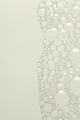 The texture of the foam of shower gel or soap suds or shaving foam. Macrophotography. Copy space