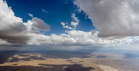 towering cumulus clouds above Kalahari desert, near Kalkrand, Namibia