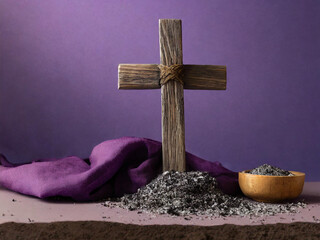 Wooden cross with ashes and purple cloth symbolizing Lent and Ash Wednesday, Christian faith and repentance concept