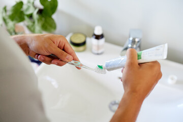 Man applying toothpaste on brush