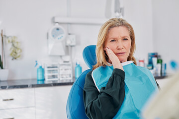 Senior woman with tooth pain at dental clinic