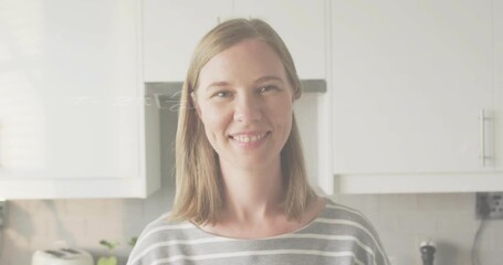 Adult woman in kitchen smiling as floating math equations appearing enhancing education engagement - Powered by Adobe