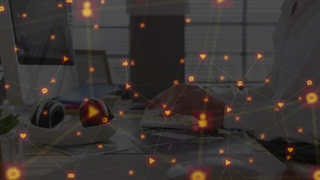 Animation of media icons over diverse business people using computers
