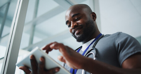 Black man, doctor and smile with tablet in hospital for research, medical report and test results....