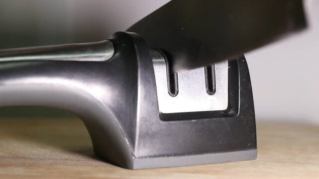 Knife sharpener kitchen tool blade sharpening metal handheld design closeup home appliance utensil equipment countertop household