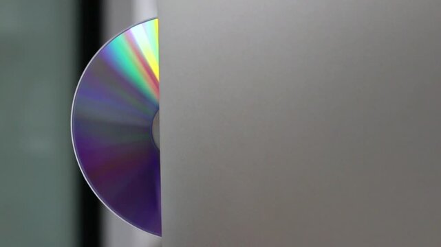 Compact disc slot load rainbow reflection minimal blur soft gray wall texture calm background minimal abstract slot load optical
