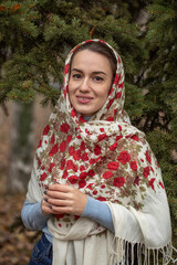 Portrait of a young beautiful woman with a scarf on her head