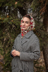 Portrait of a young beautiful woman with a scarf on her head