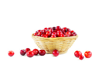 Cranberries in a wicker basket isolated on a white background.