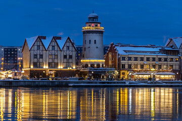 The Fishing Village reflected in the river on a winter evening