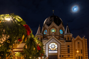 View of the Kaliningrad Synagogue at night in winter, with Christmas tree decorations in the foreground